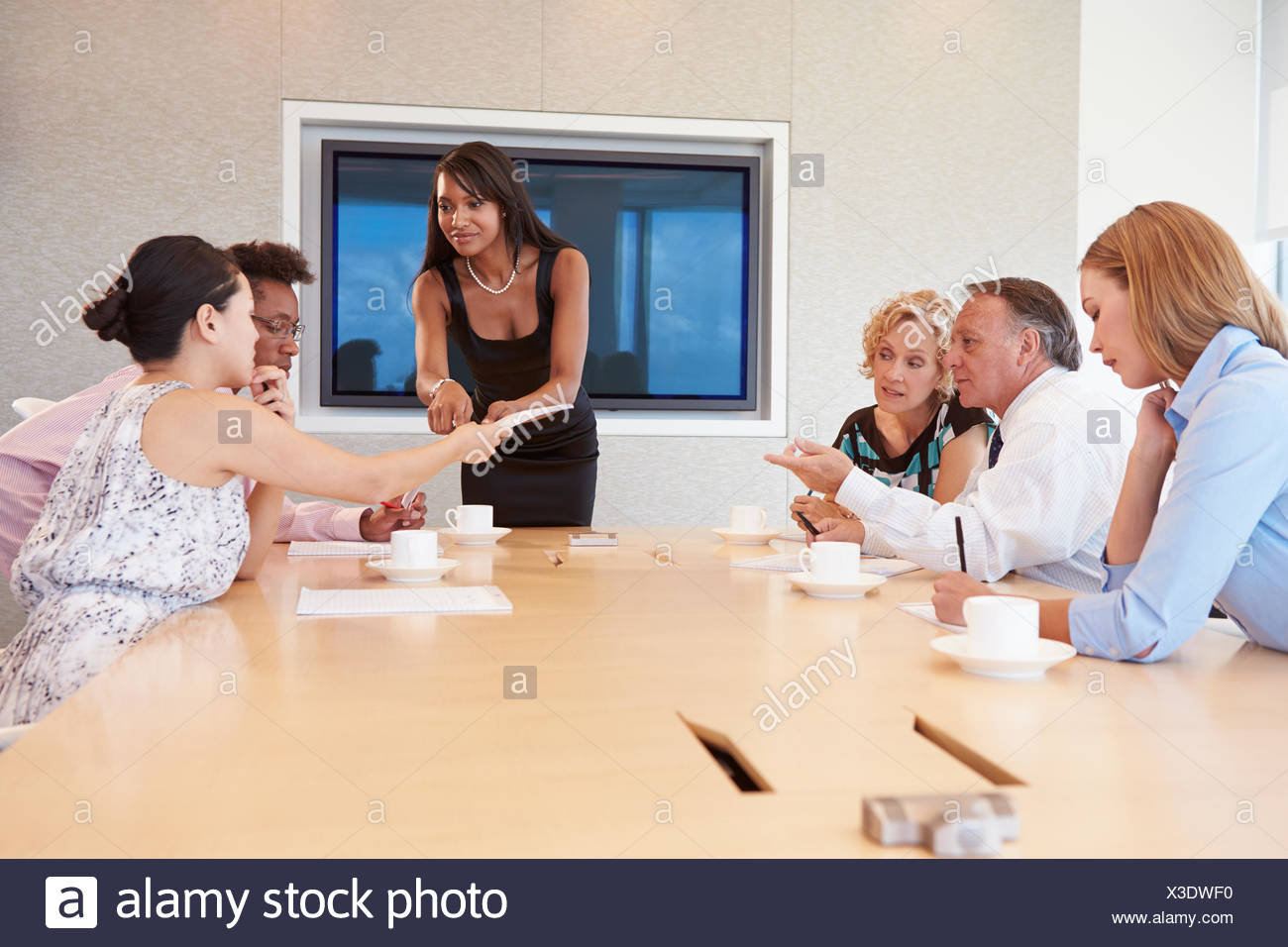 Businesswoman By Screen Addressing Boardroom Meeting Stock