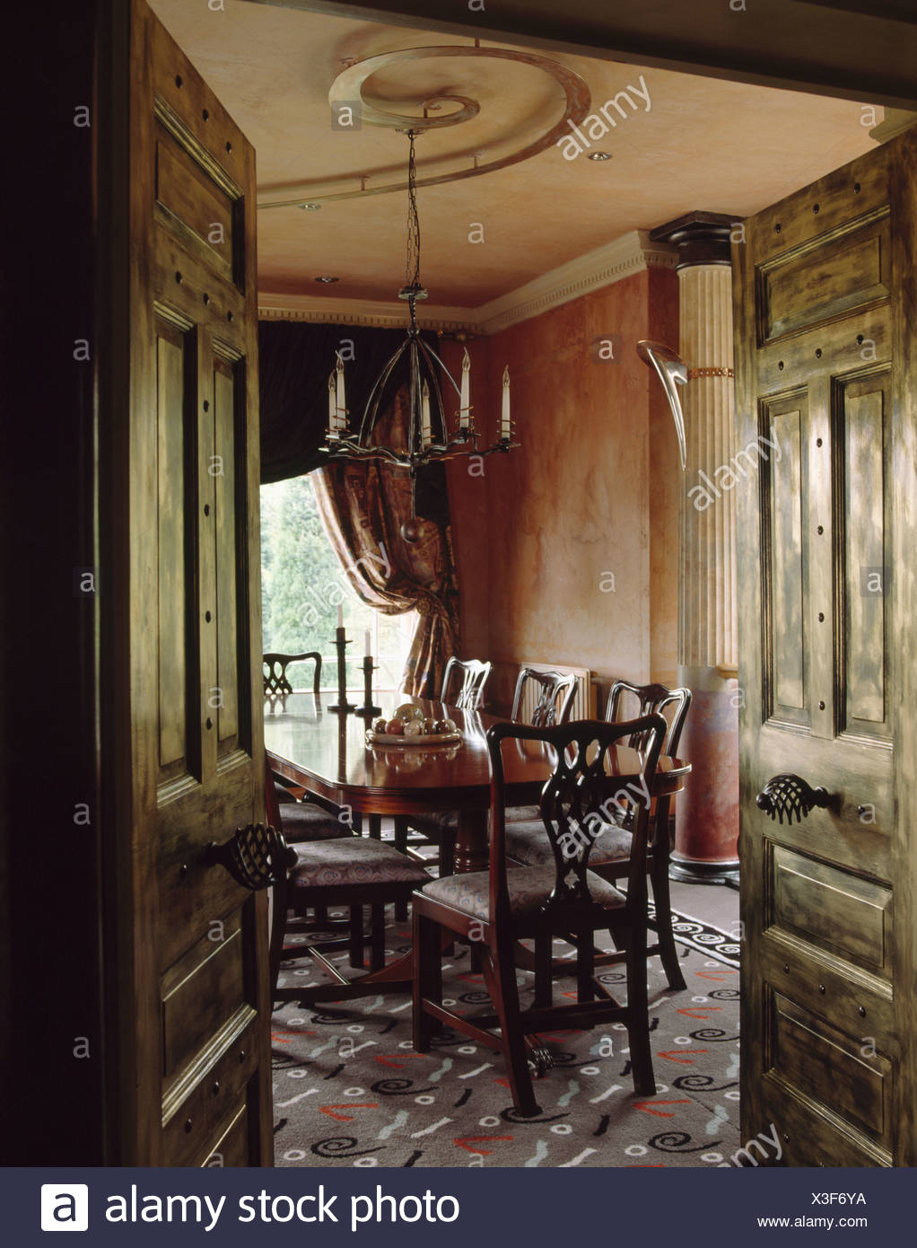 Double Painted Olive Green Doors Open To Dining Room With