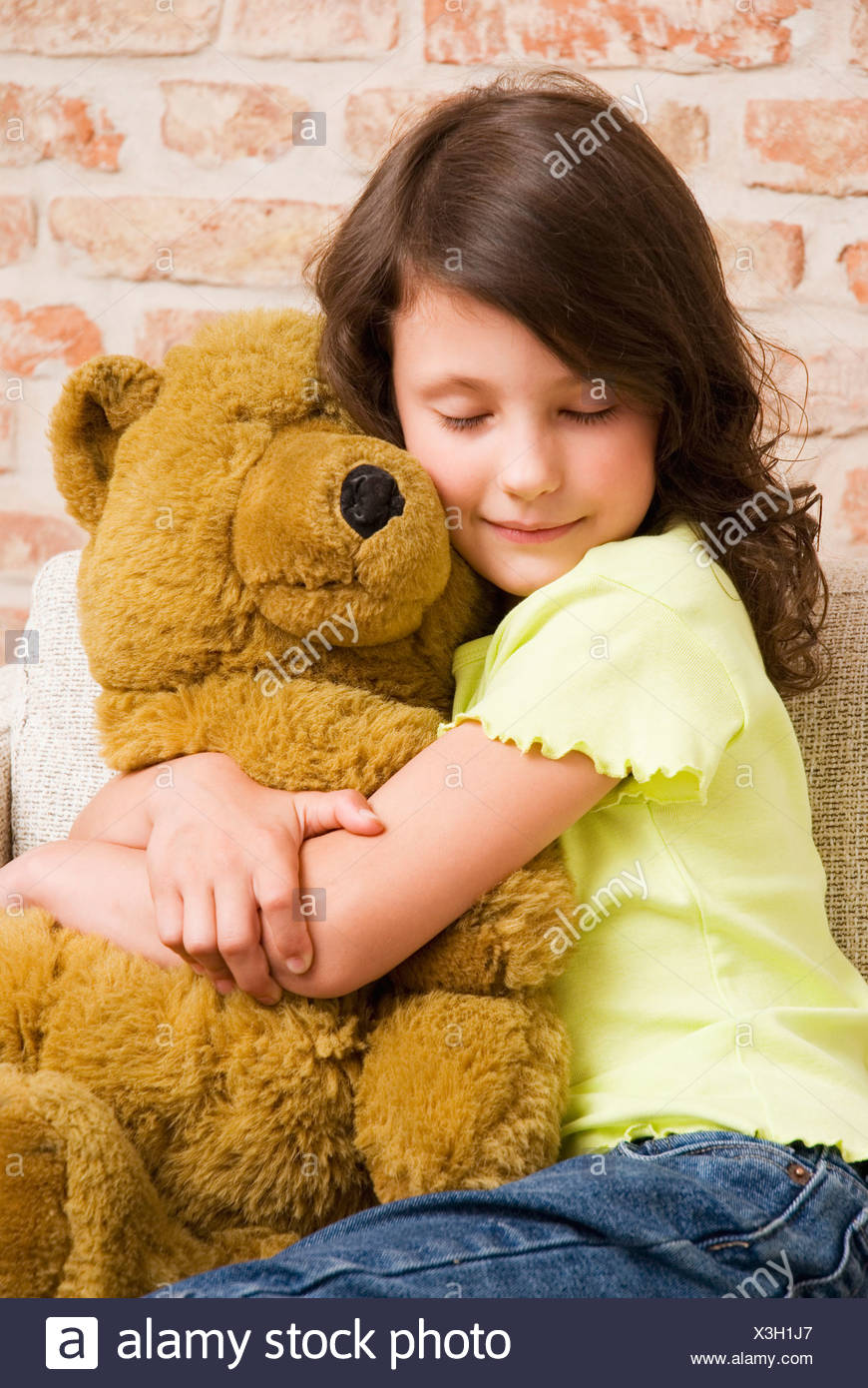 girl hugging teddy bear