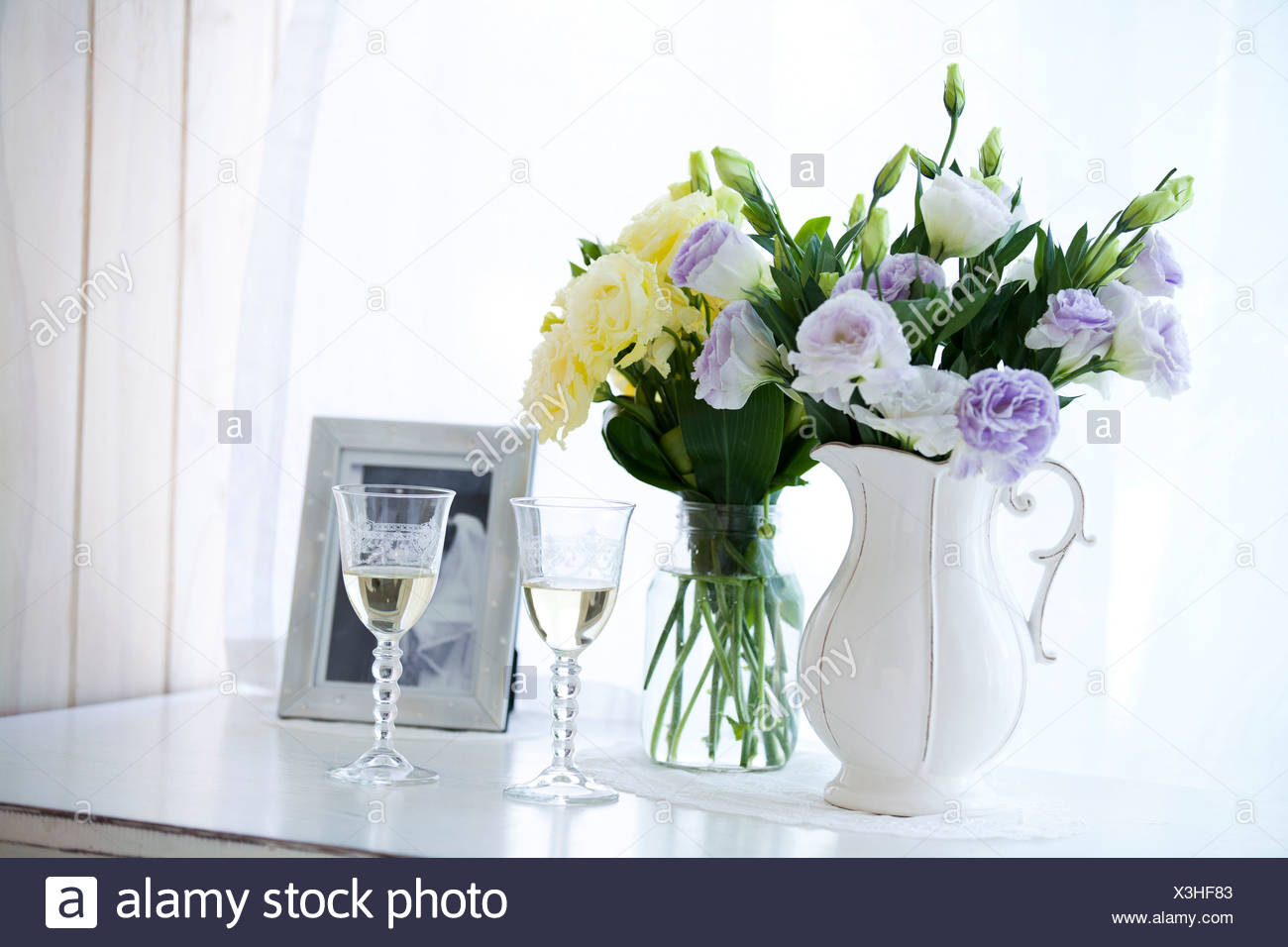 Close Up Of Wine Glasses With Flower Vase And Photograph Stock