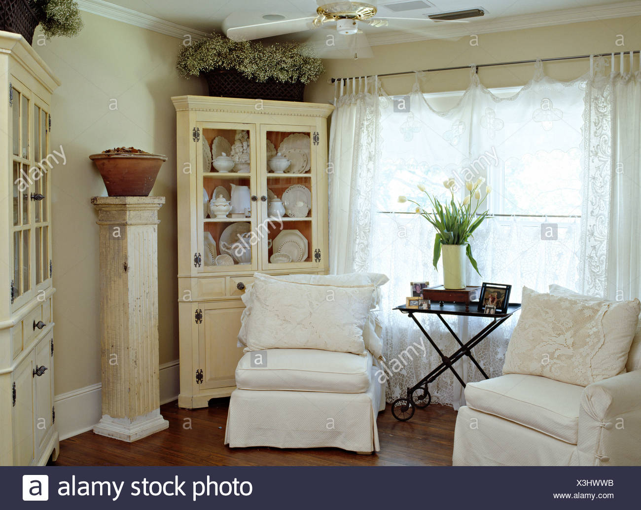 White Loose Covers On Chairs In Front Of Window With Lace Curtains