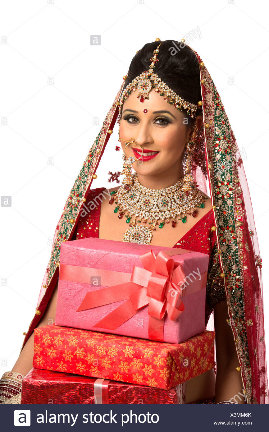Smiling Indian Bride In Traditional Wedding Dress Holding Gifts