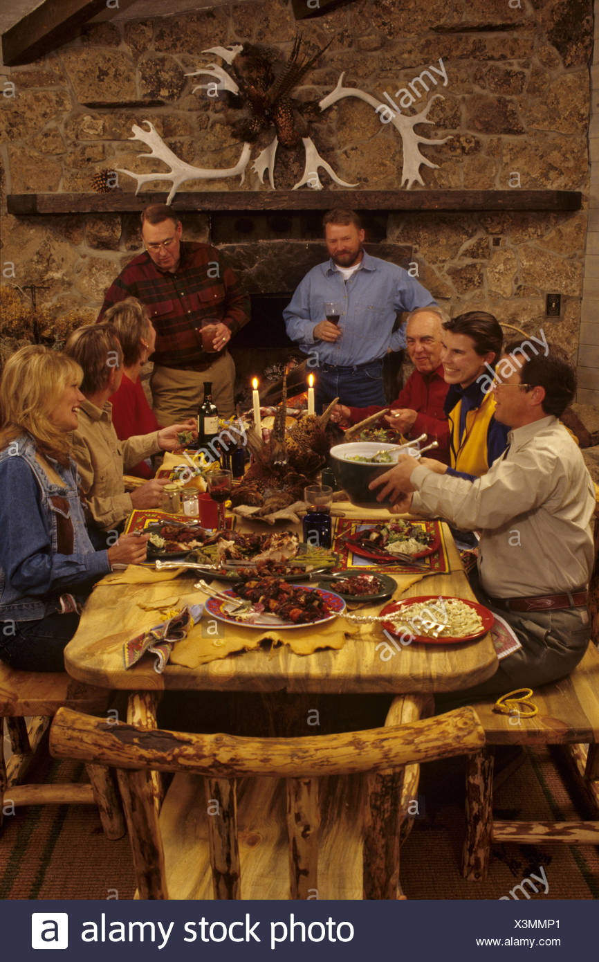 Friends And Family Gathered Around The Table For A Dinner Party Stock Photo Alamy
