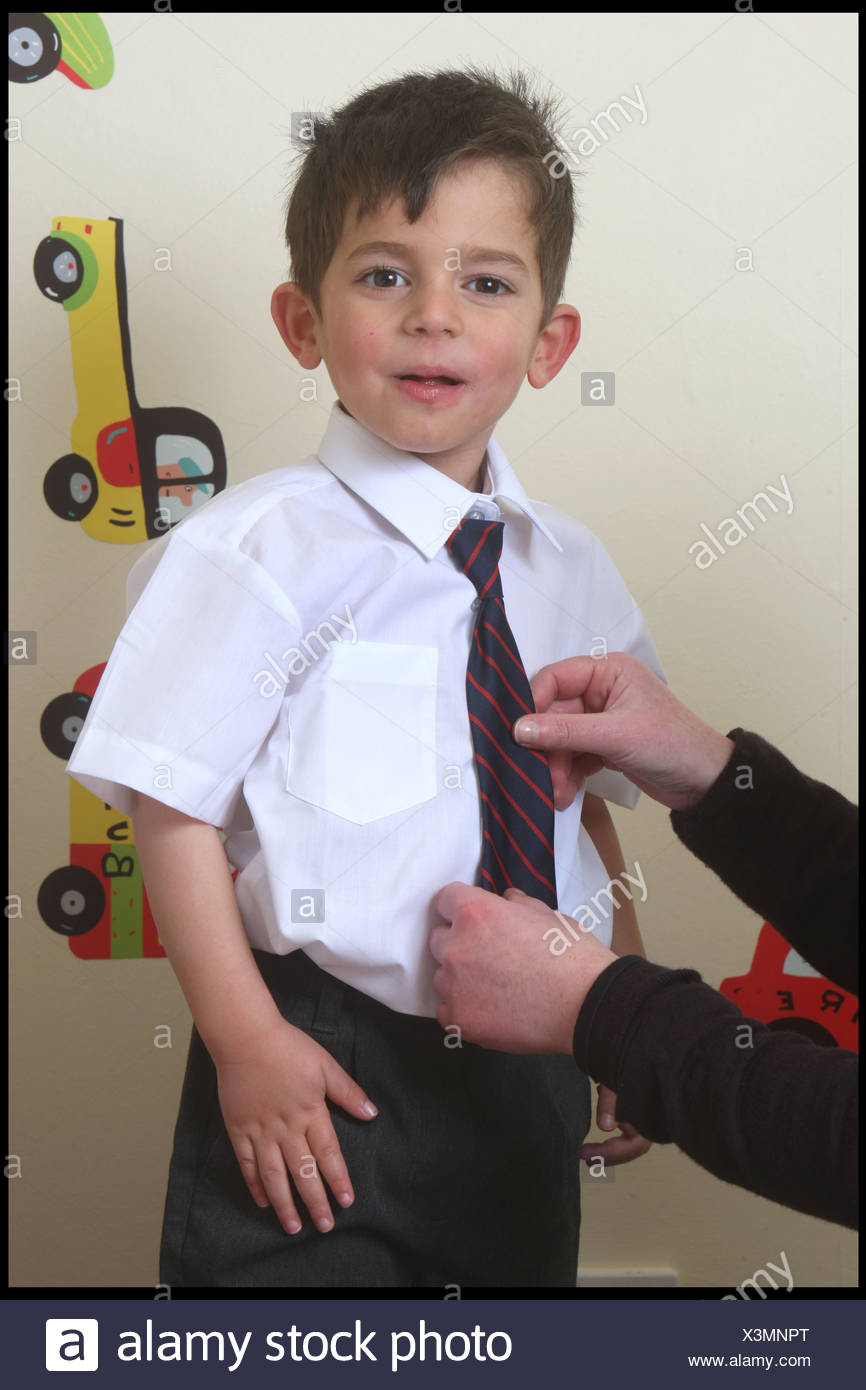 Male Child With Brunette Hair Wearing A White Shirt Striped Tie