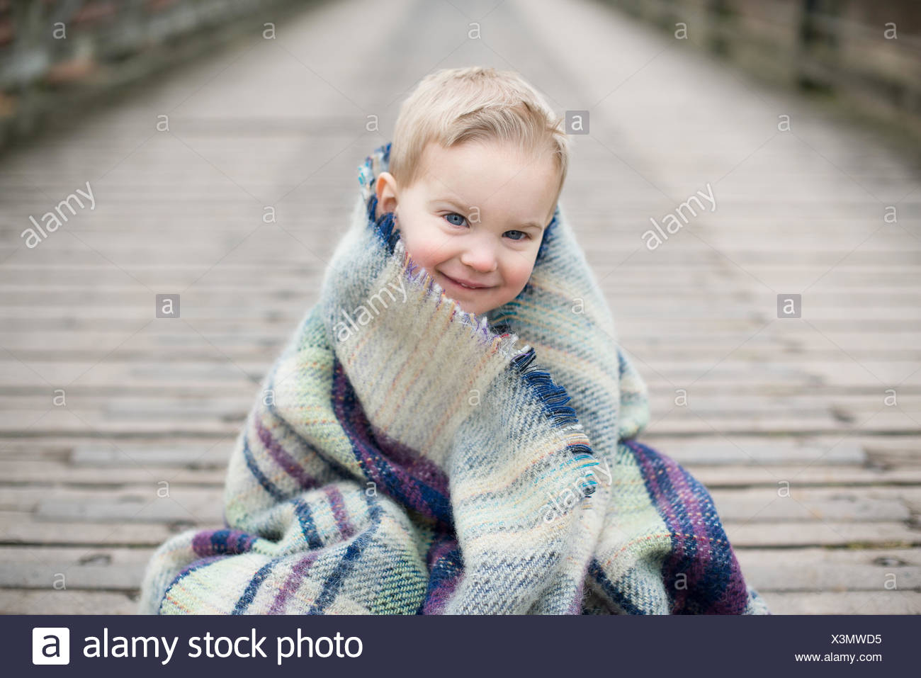 child wrapped in blanket