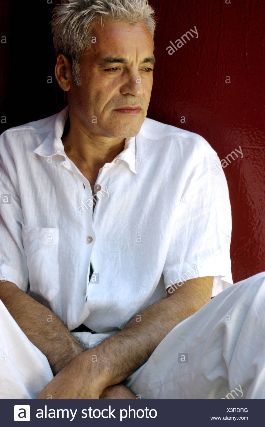 Male Grey Hair Wearing A White Short Sleeved Crinkled Shirt