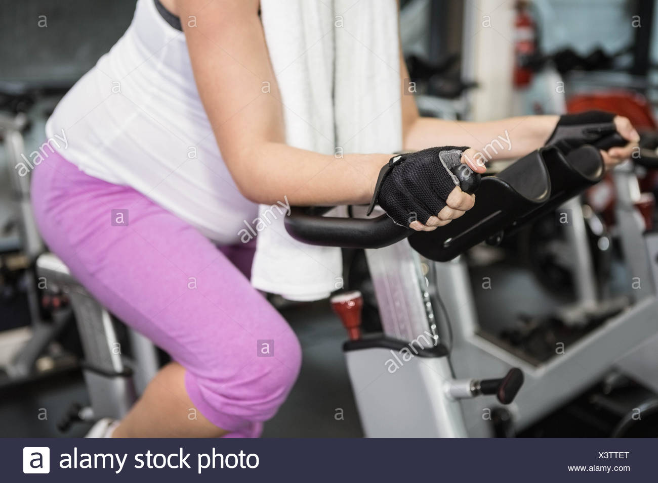 Woman Pregnant Riding Bike Side Stock Photos & Woman Pregnant Riding