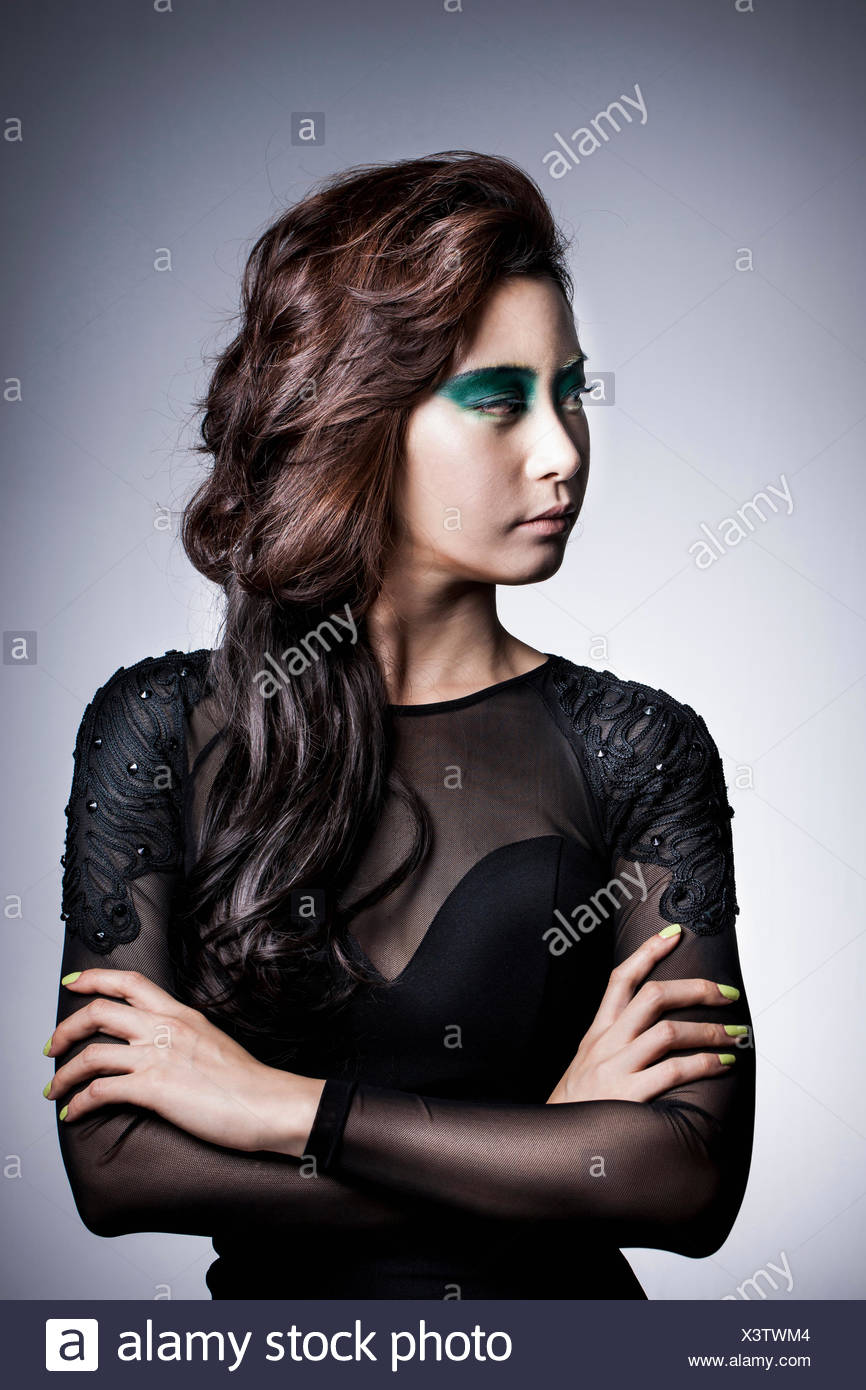 Side View Of Young Korean Woman With Long Wavy Hair And In Green