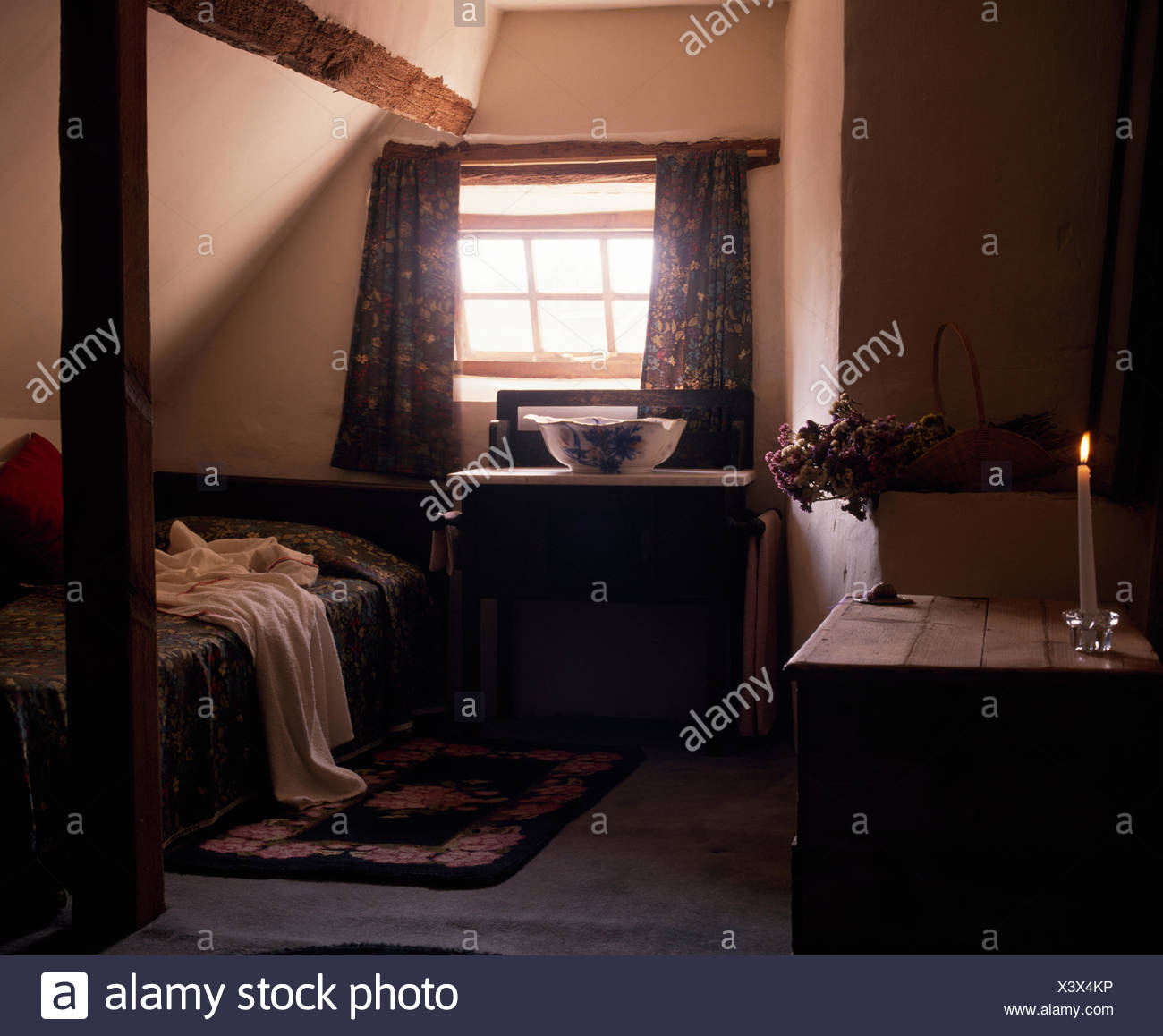 Lighted Candle On Table In Dark Victorian Style Attic