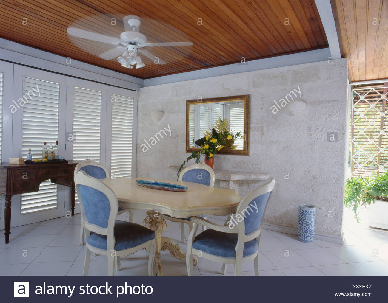Ceiling Fan Above Cream Table And Traditional Blue Upholstered