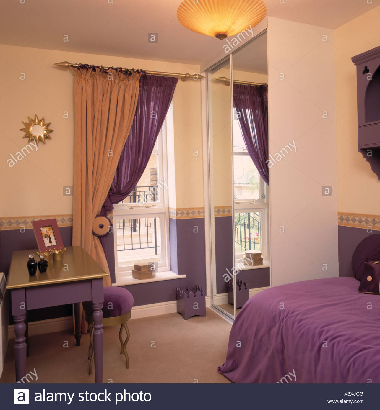 Purple And Gold Curtains At Window Beside Fitted Wardrobe With