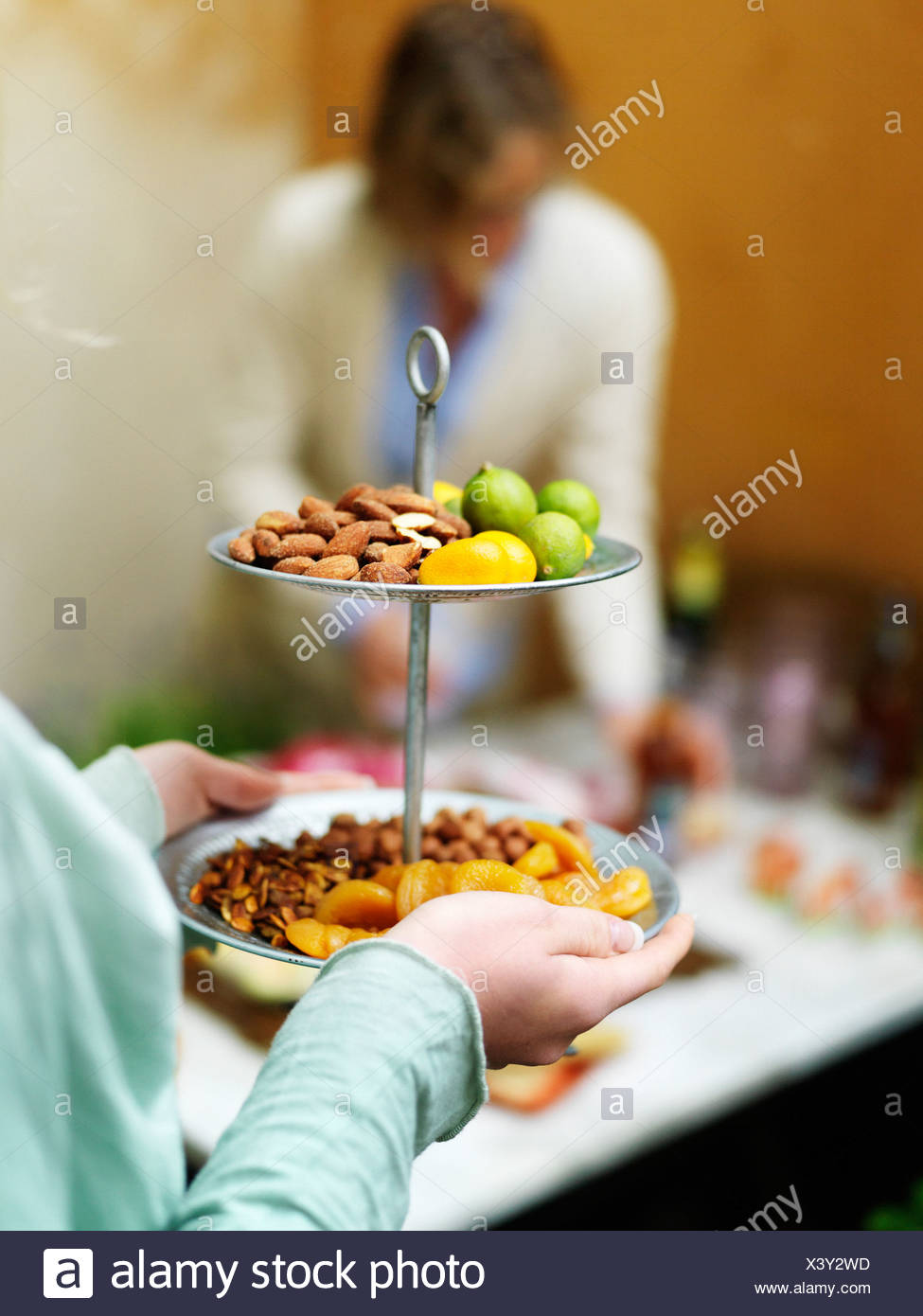Close up of woman serving fruits and nuts Stock Photo