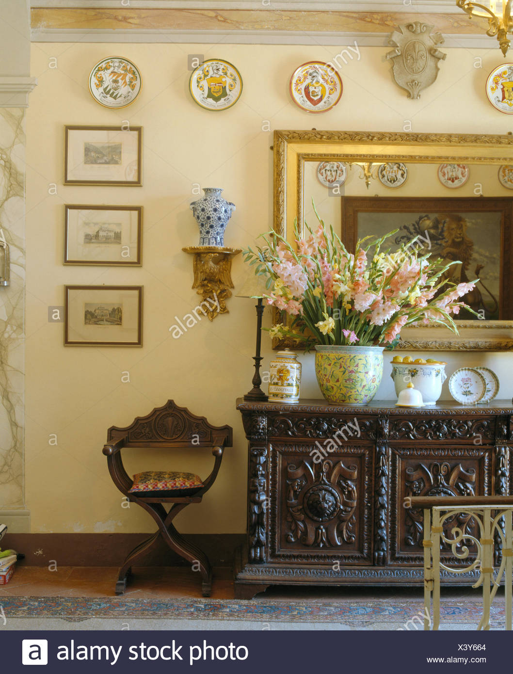 Large Vase Of Gladioli On Ornately Carved Wooden Sideboard In Tuscan Dining Room Stock Photo Alamy