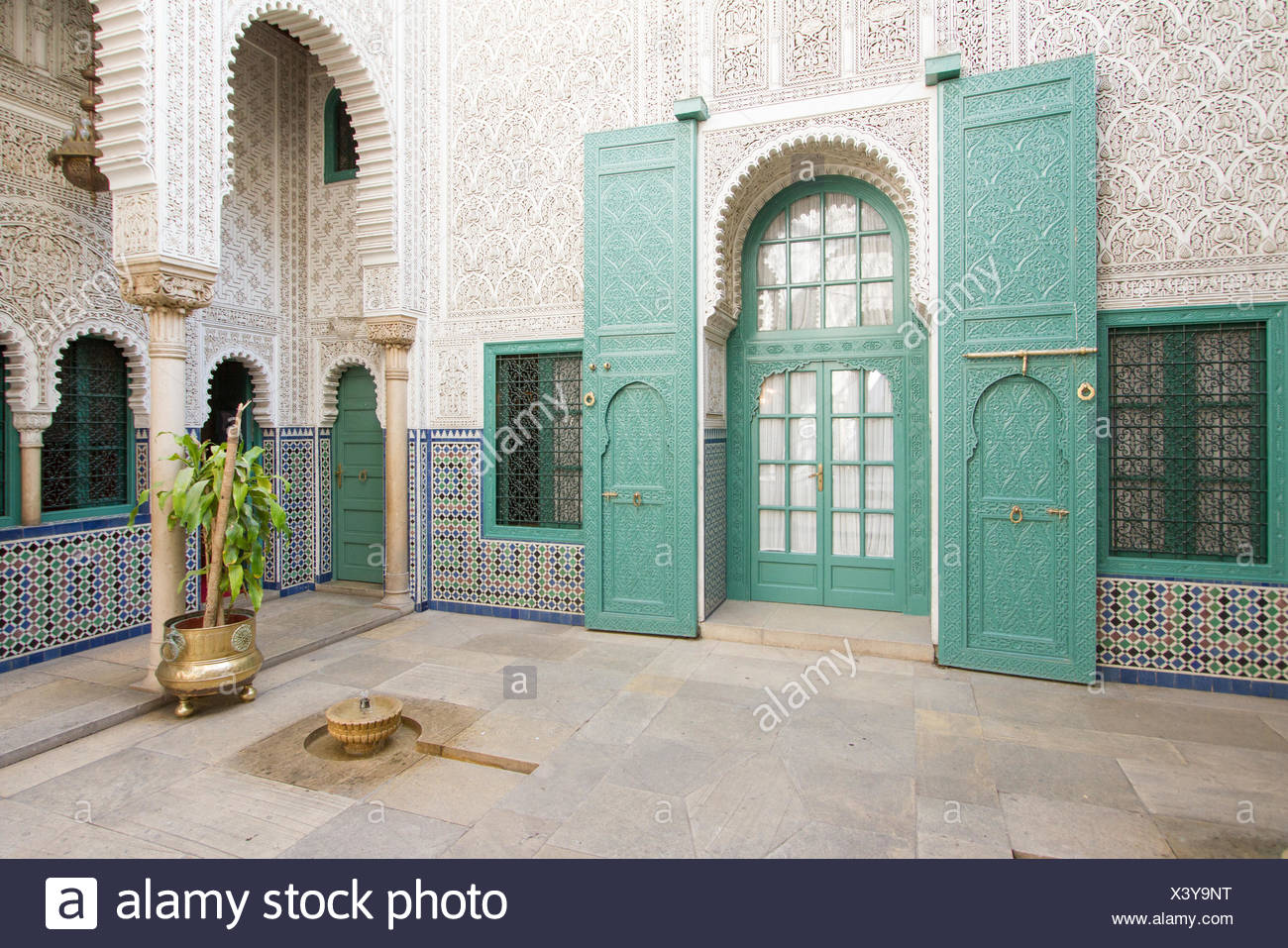 Ornate Wood And Tilework With Teal Windows And Doors From