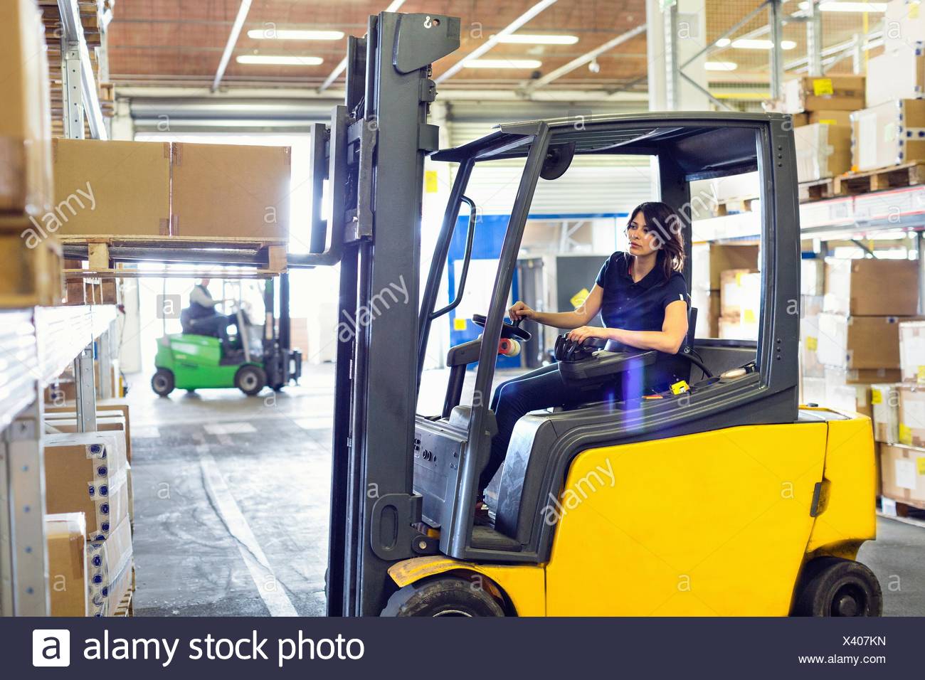 Female Forklift Truck Driver Working In Distribution Warehouse Stock Photo Alamy