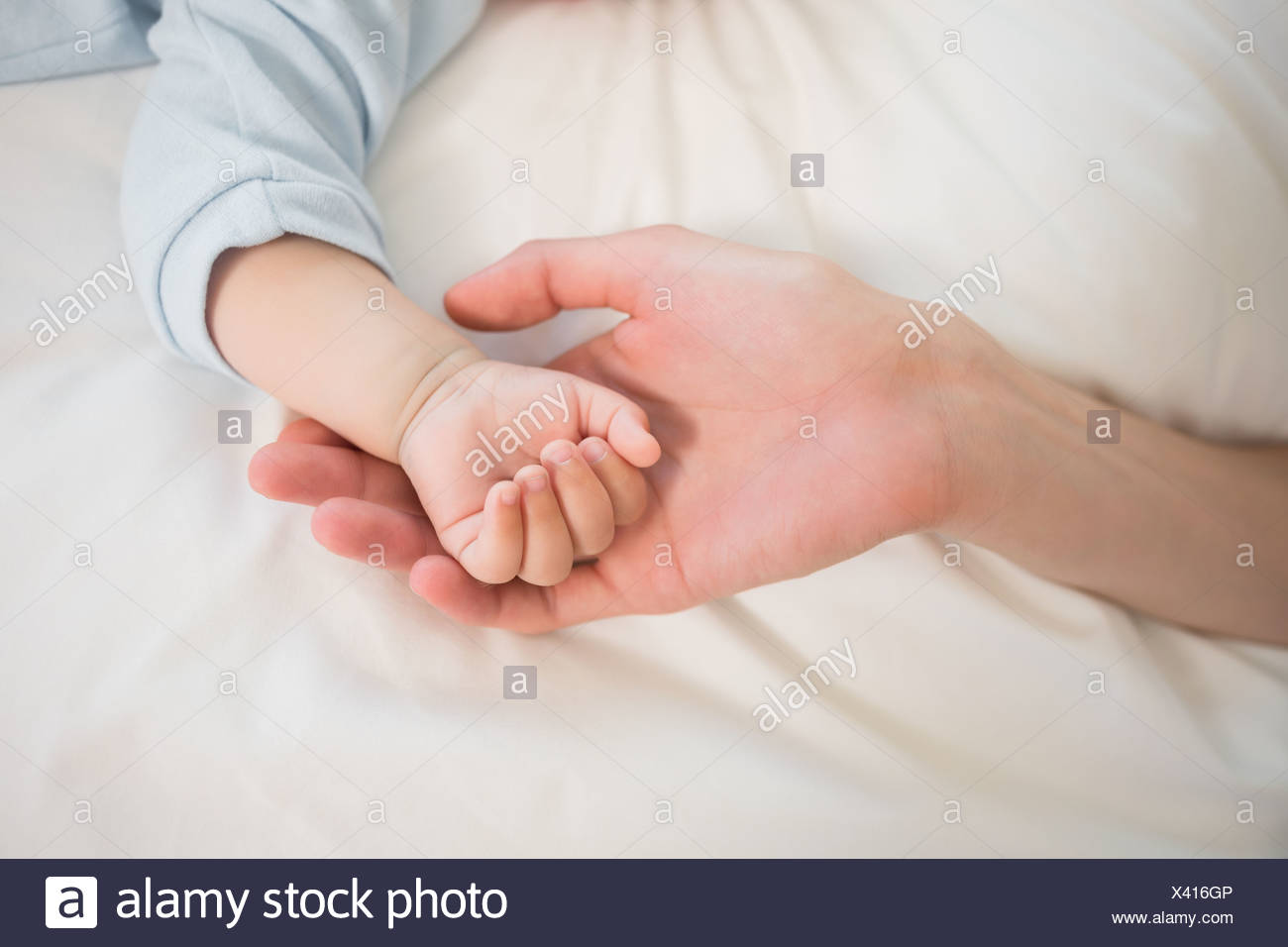 Mother Holding Baby Sons Hand Stock Photo 277851638 Alamy