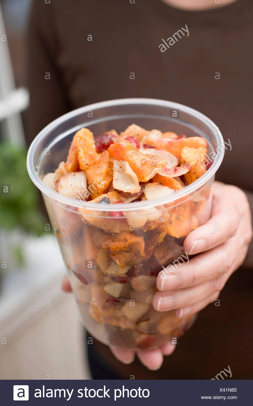Woman Holding Vegetable Dish In Plastic Tub Stock Photo