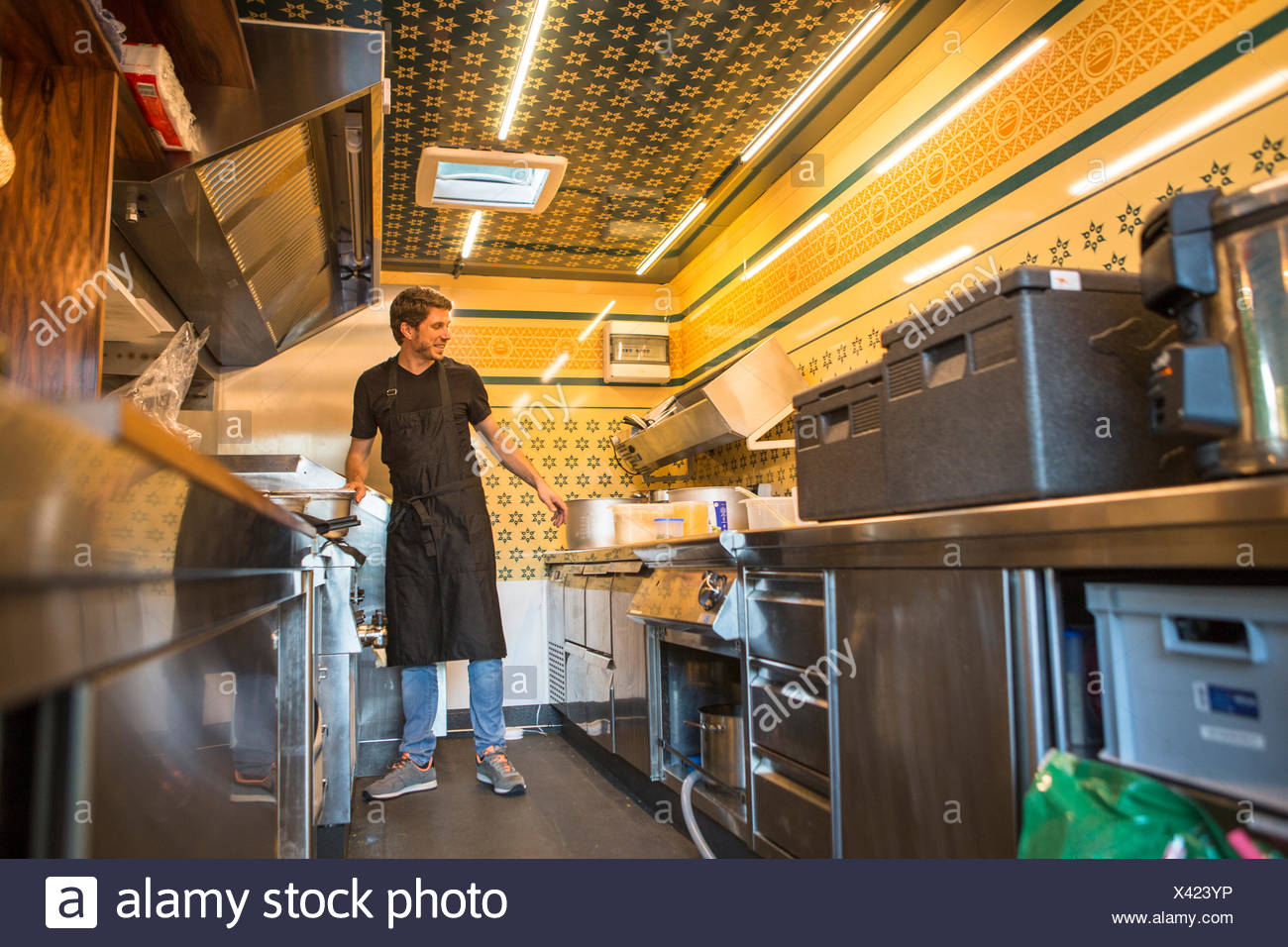 Entrepreneur With Apron Working In Commercial Kitchen At