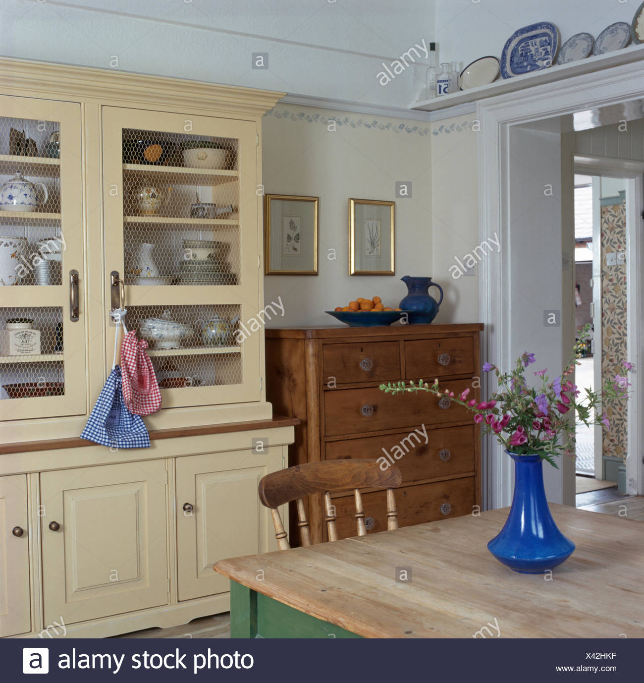 Cream Painted Dresser And Old Pine Chest Of Drawers In A Country