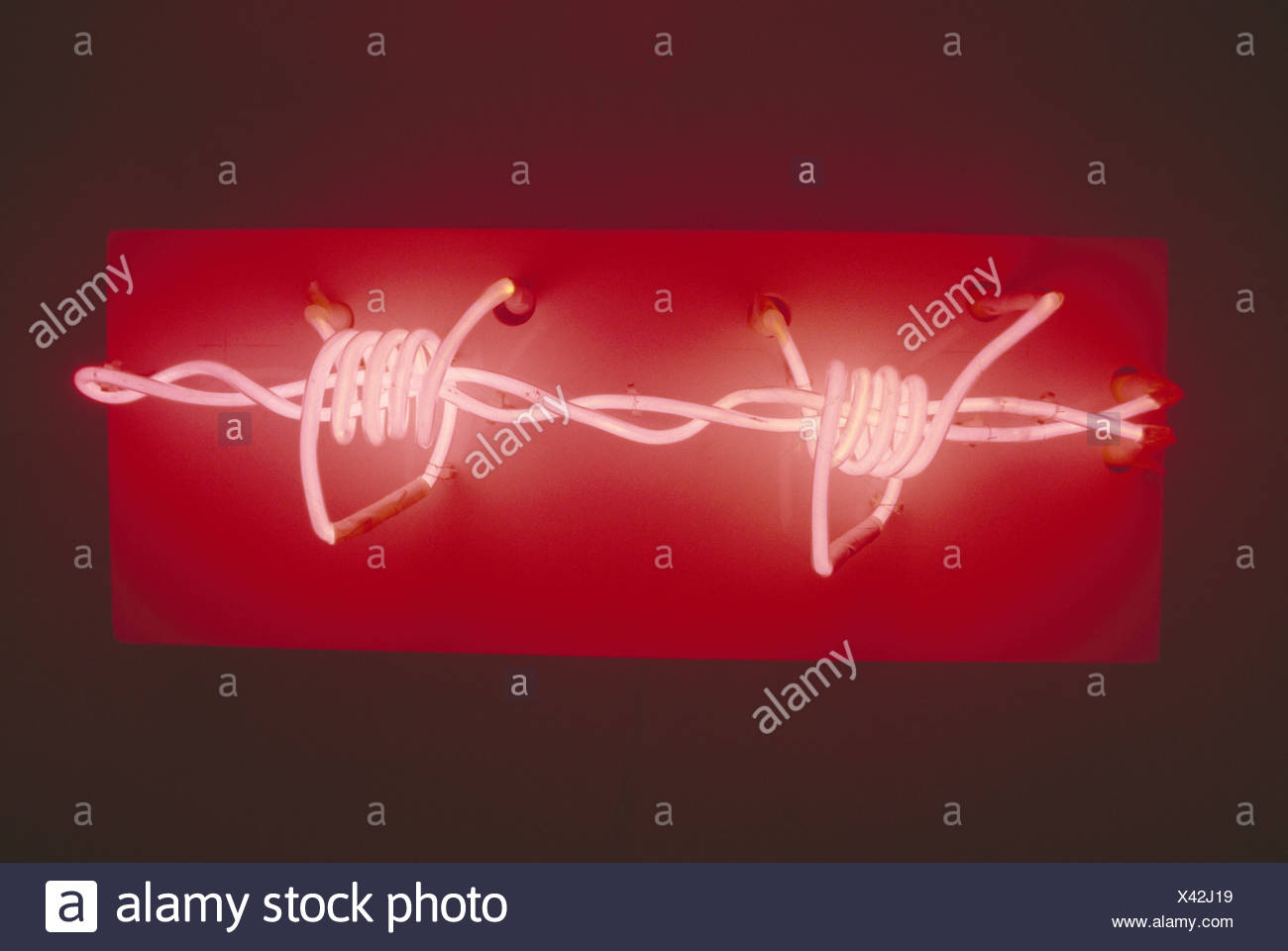 Close up of red and white neon lighting in barbed wire shape