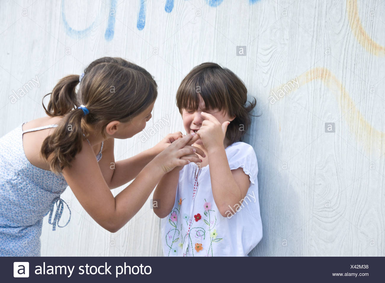 Girl Trying To Comfort A Young Crying Girl Stock Photo 277884188