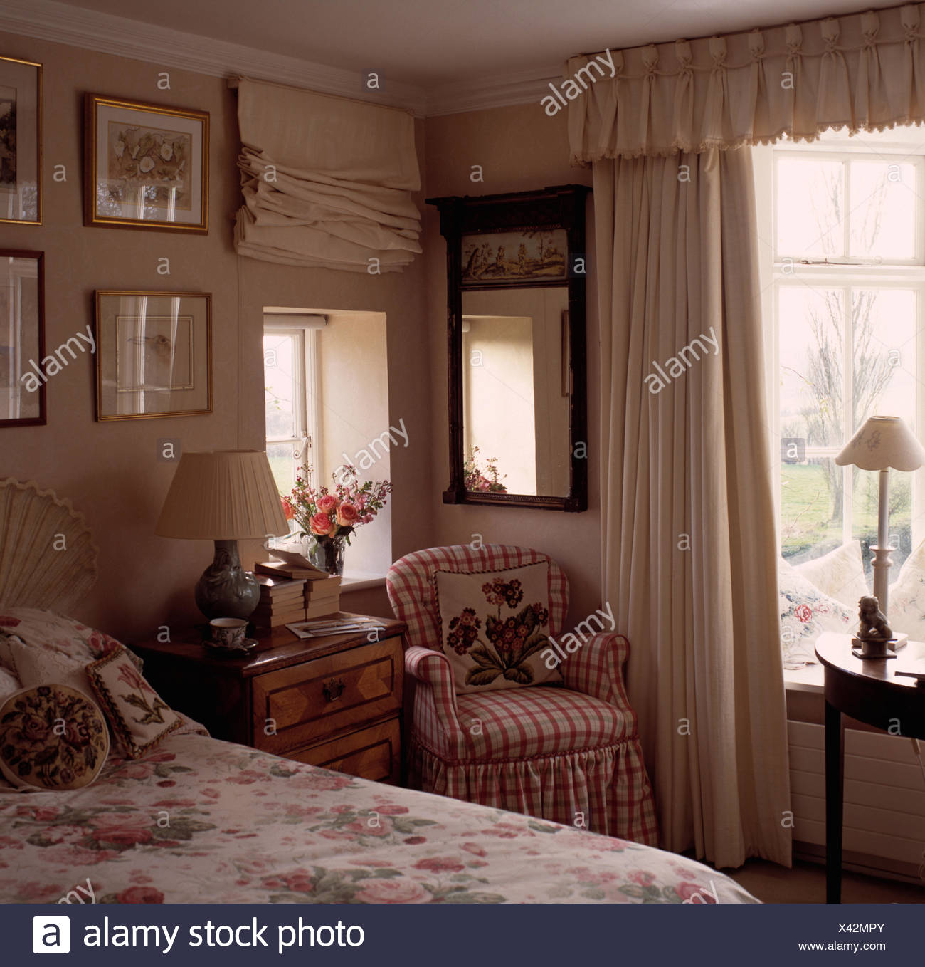 Cottage Bedroom With Antique Mirror And Checked Armchair In Corner