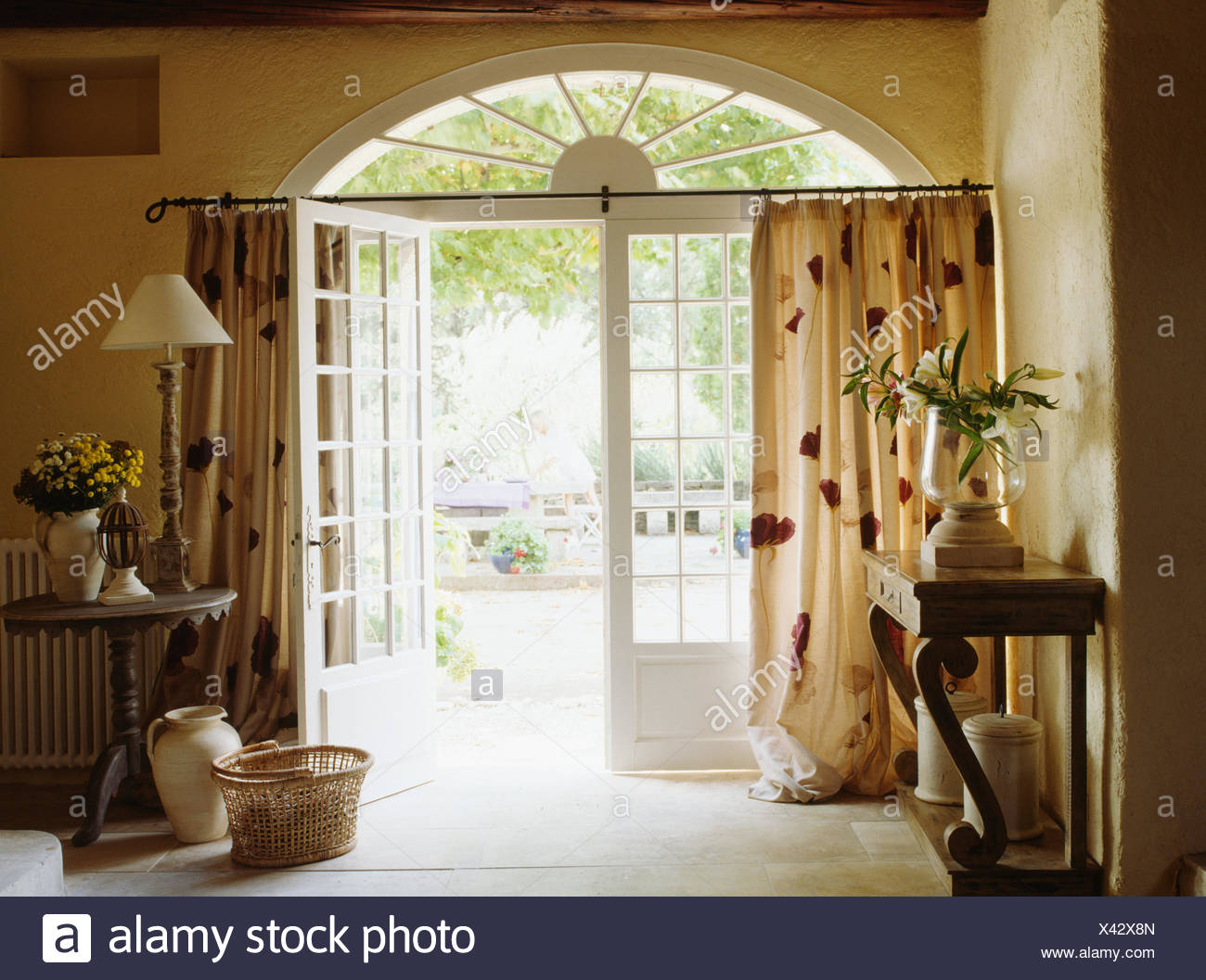 French Country Hall With Patterned Cream Curtain On Half
