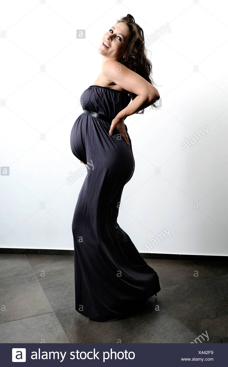 Woman With A Pregnant Belly Wearing A Long Dress Stock Photo Alamy