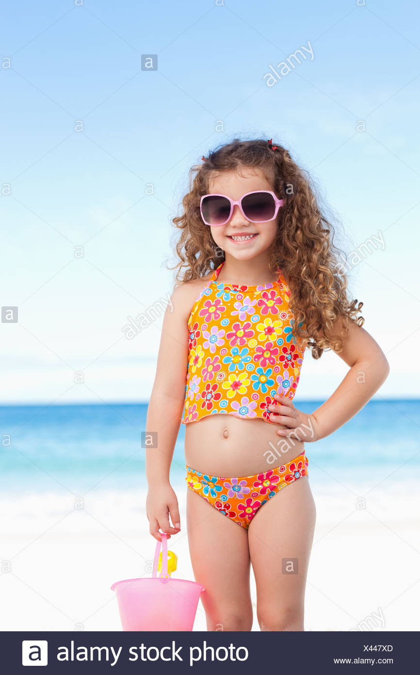 Cute Little Girl With Sunglasses Standing On The Beach Stock Photo Alamy