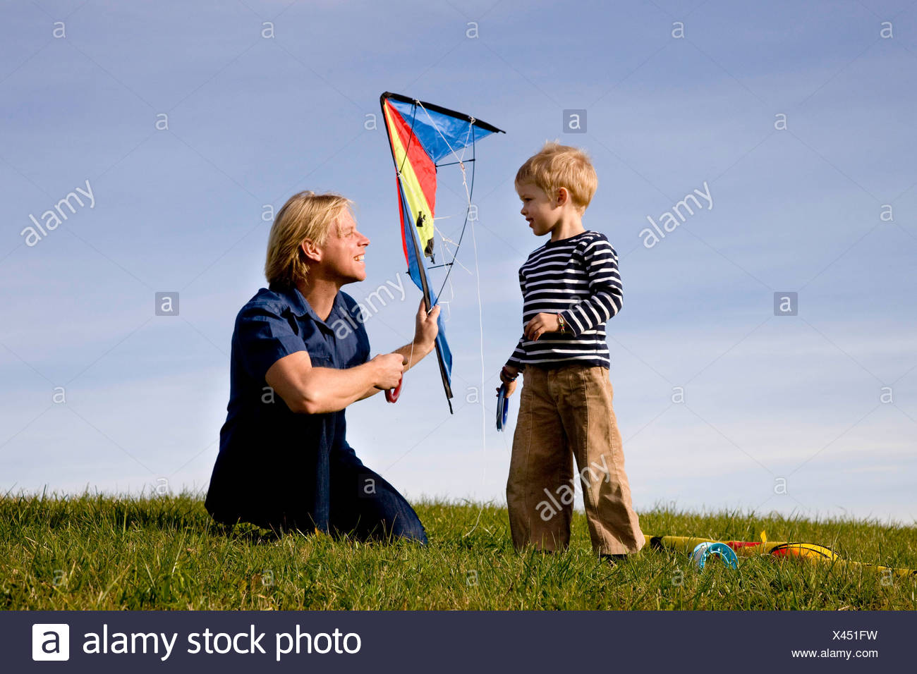 Boy and father put together a Kite Stock Photo