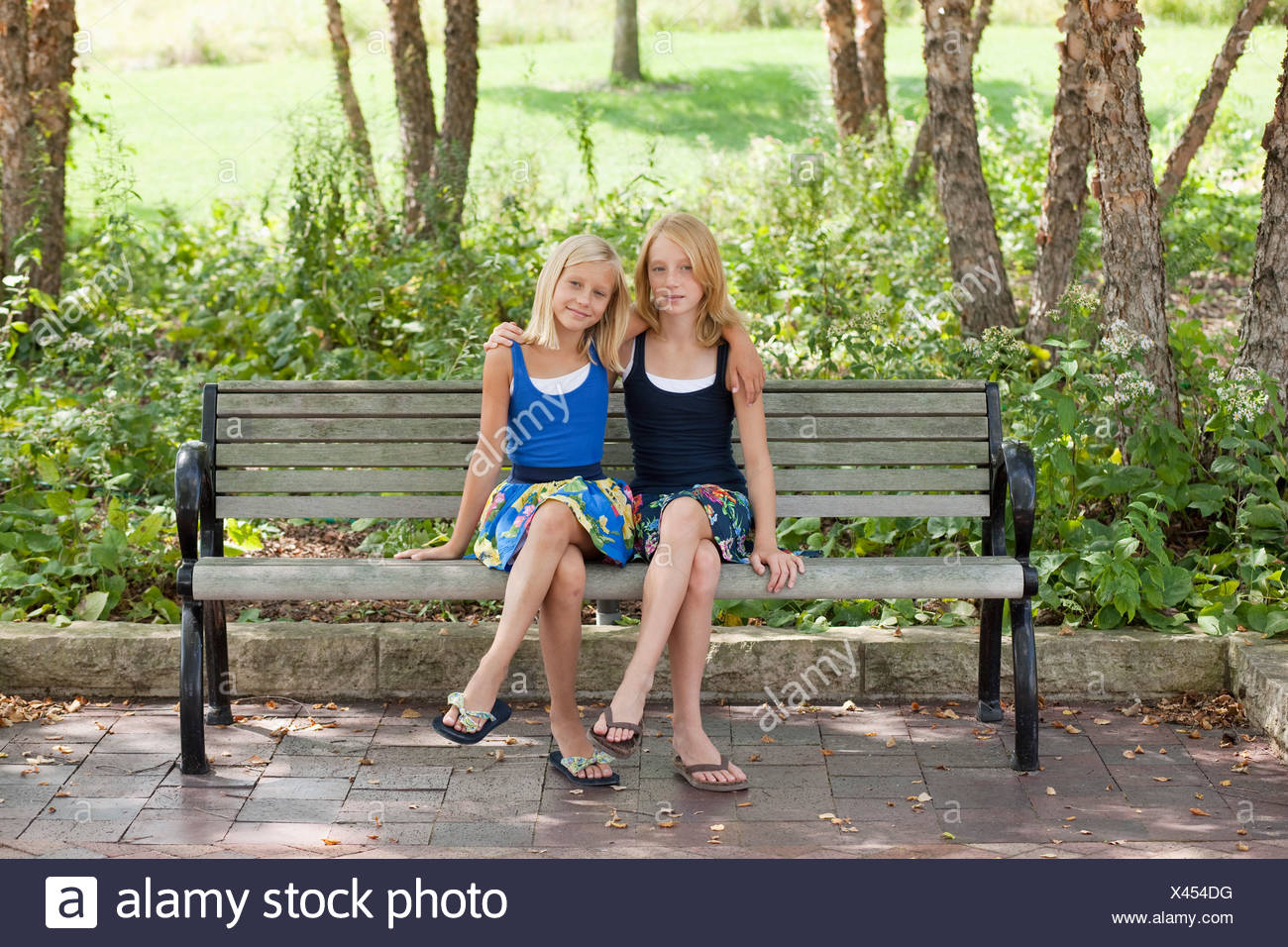 Two Girls Sitting On A Bench High Resolution Stock Photography and ...