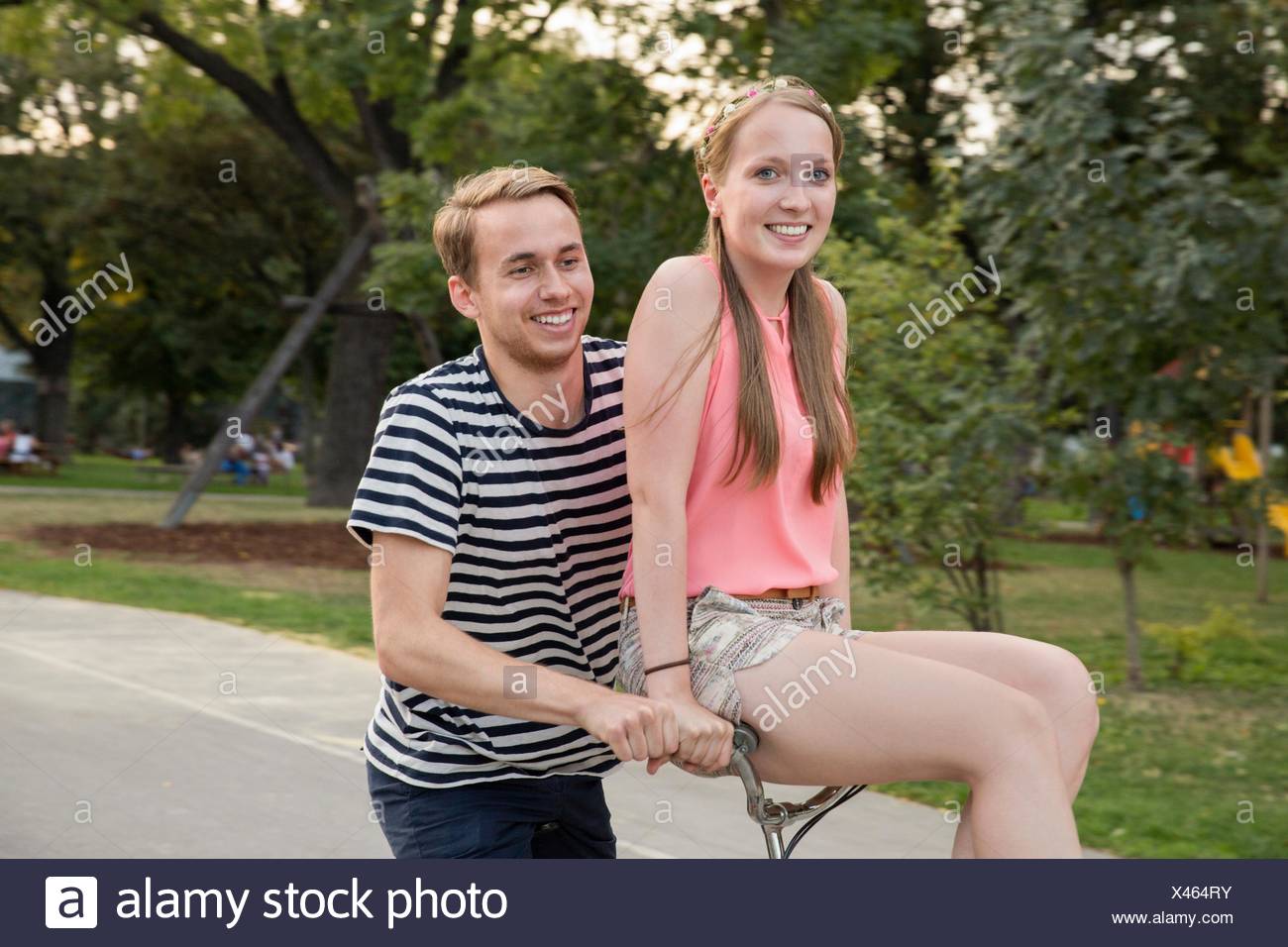 riding on the handlebars of a bike