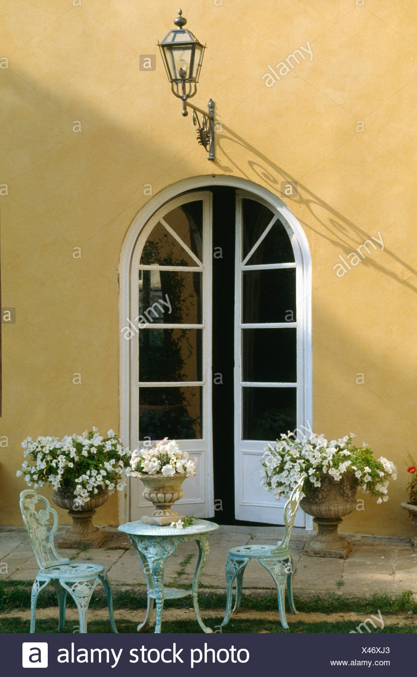 Wrought Iron Table With Matching Chairs In Front Of Italian Villa