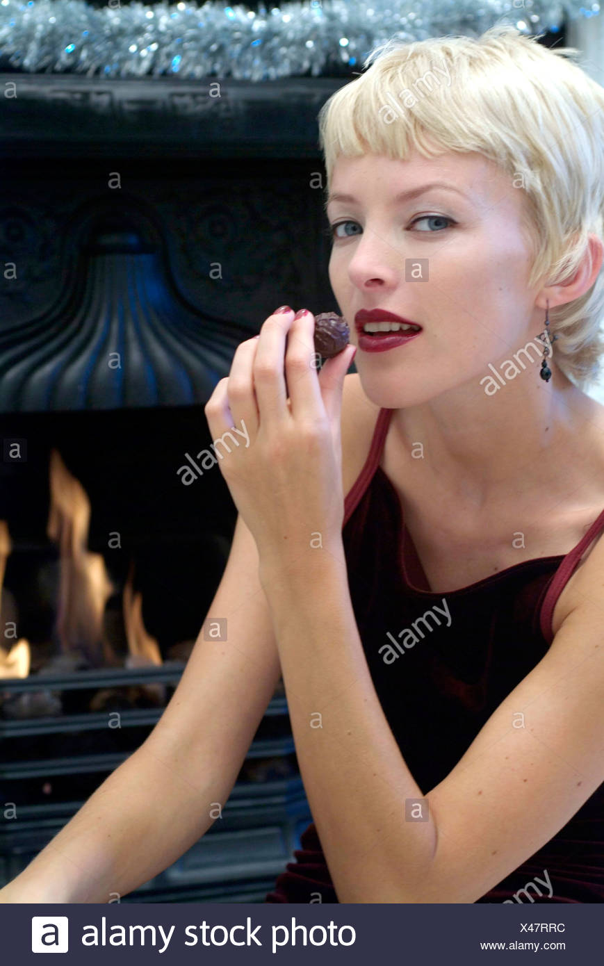 Female Short Blonde Hair Dark Red Lipstick Wearing Black Earrings