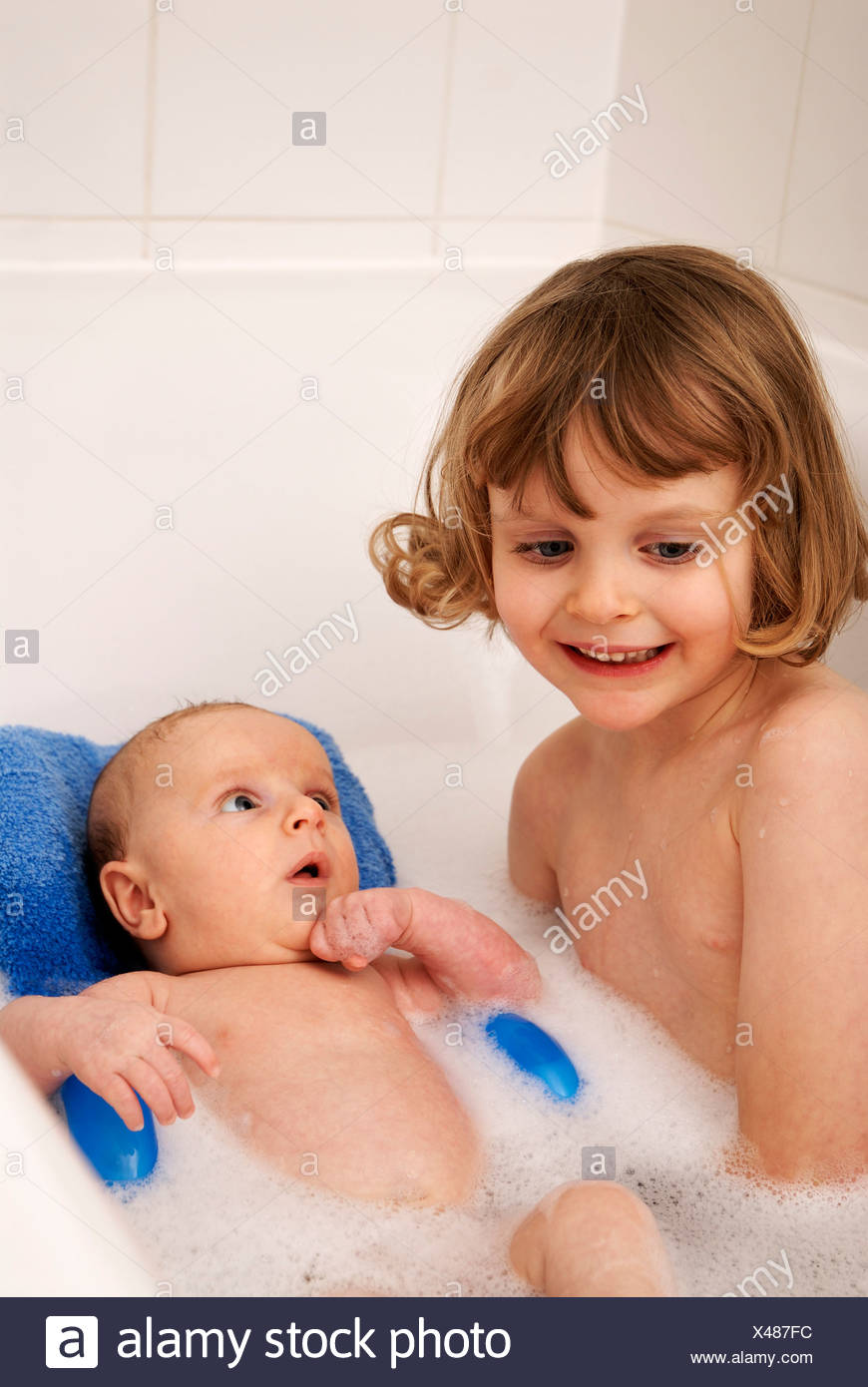 Little Girl And Her Brother Sitting In A Bath Tub 4 Years