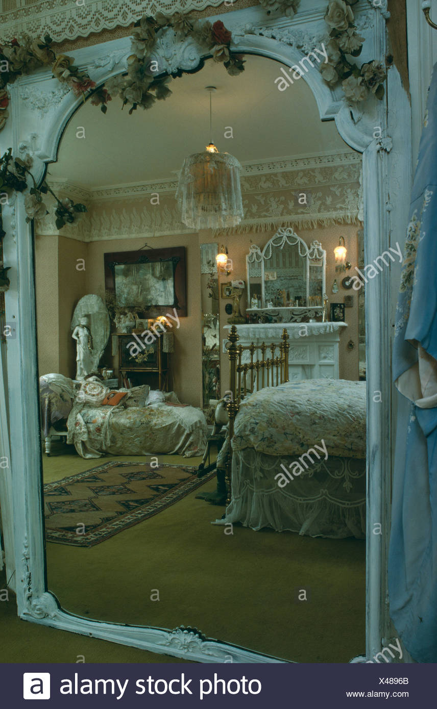 Reflection Of Victorian Bedroom In Large Mirror Stock Photo