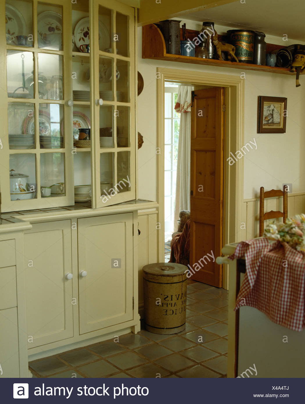 Fitted Cream Dresser With Glazed Doors In Country Kitchen Stock