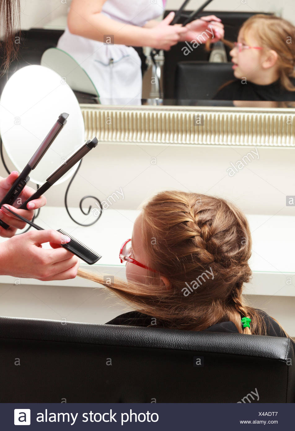 In Hairdressing Salon Little Girl Child Sitting On The Chair By