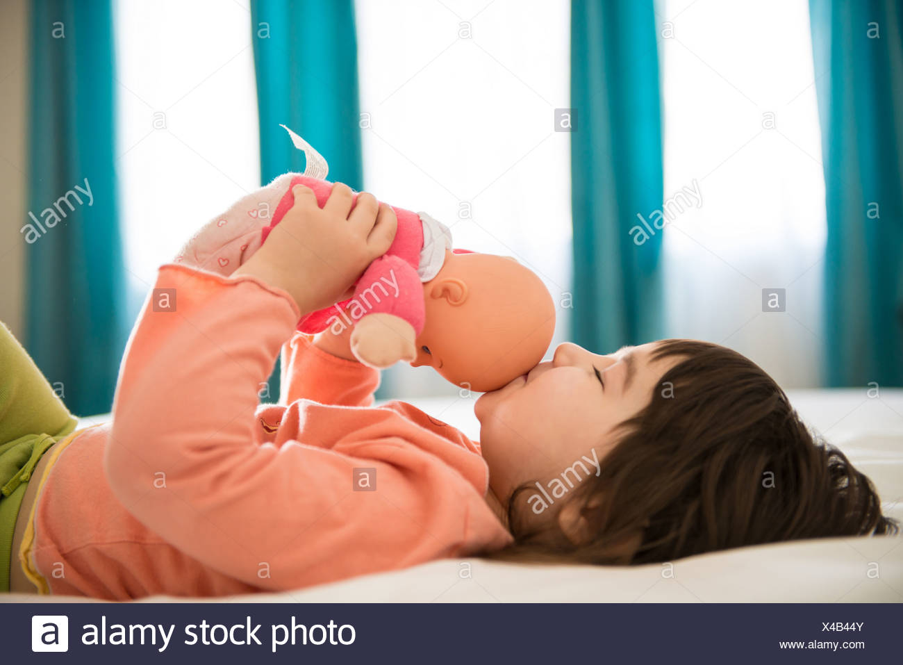 Girl Kissing Dolly In Bedroom Stock Photo 278069259 Alamy