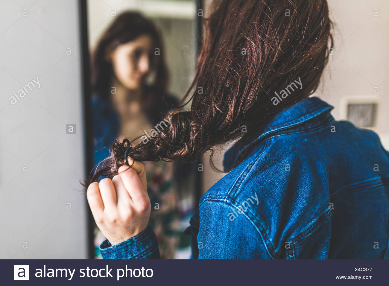 Woman Doing Hair In Mirror High Resolution Stock Photography and Images ...