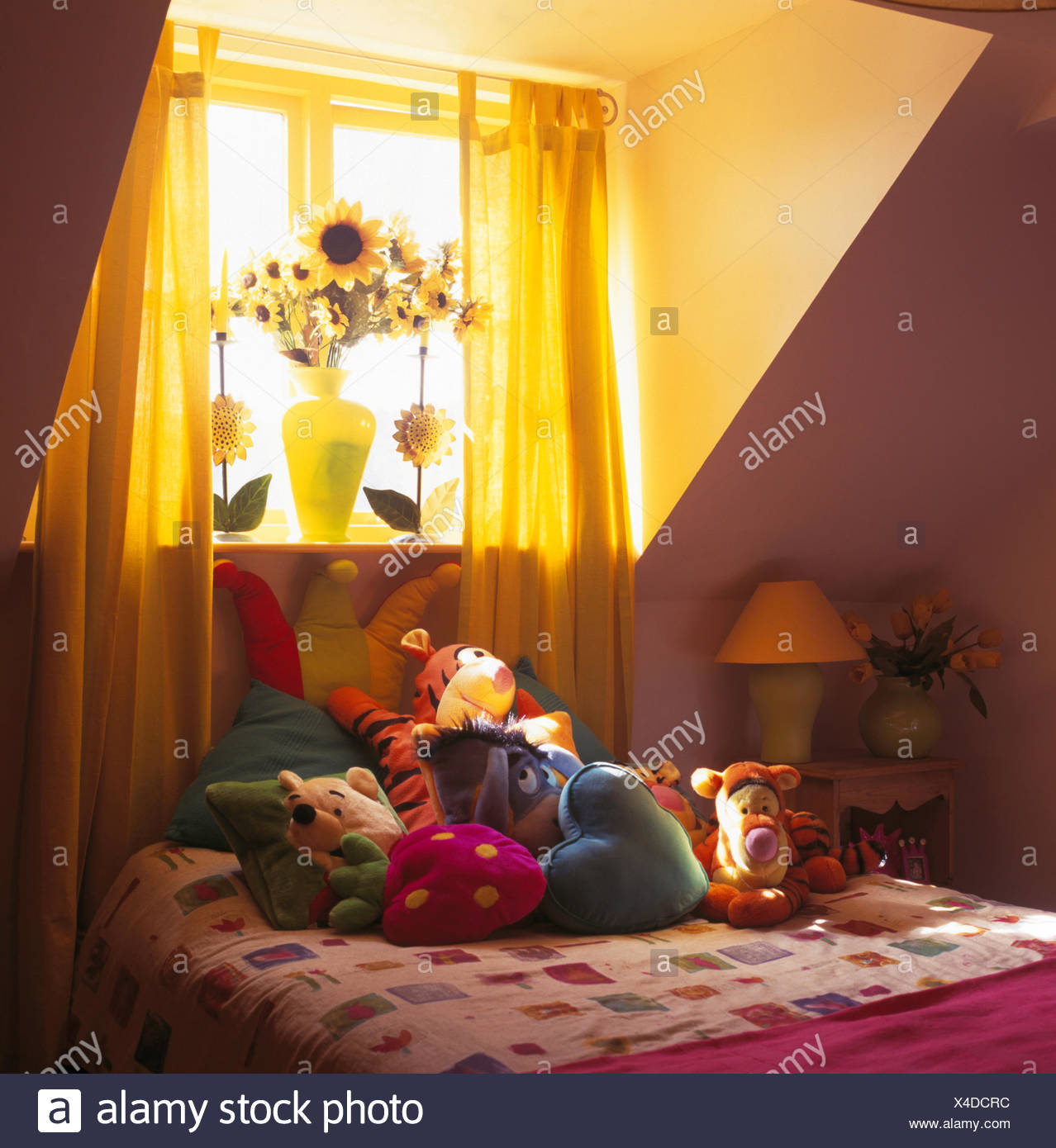 Sheer Yellow Drapes On Window Above Soft Toys On Bed In