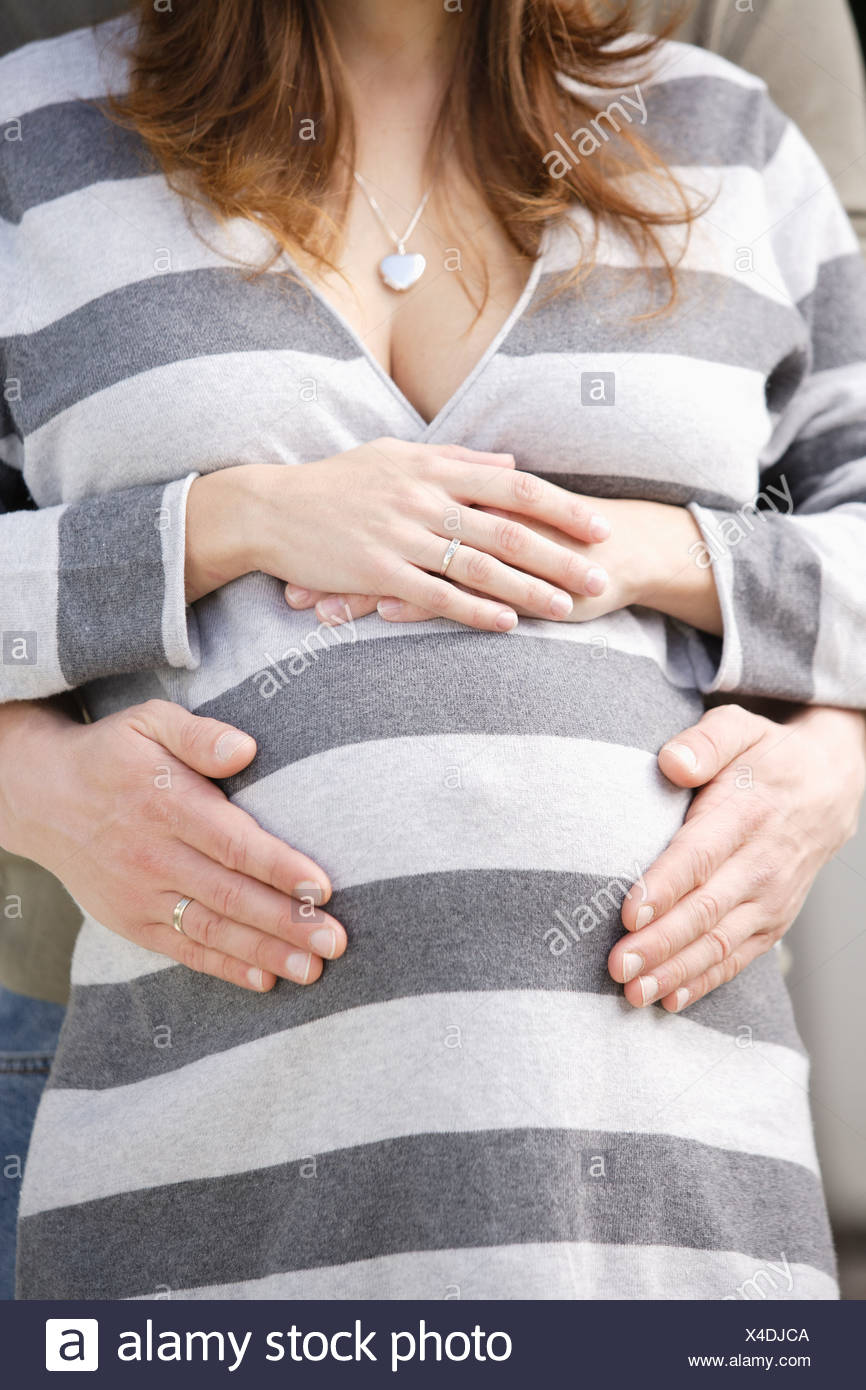 USA,California,Los Angeles,man's hands on pregnant woman's belly Stock Photo