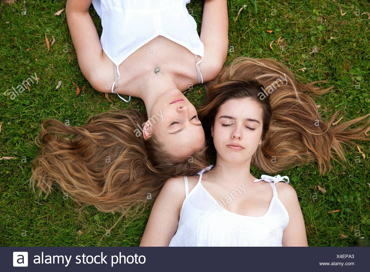 Two Girls Lying On Grass High Resolution Stock Photography and Images