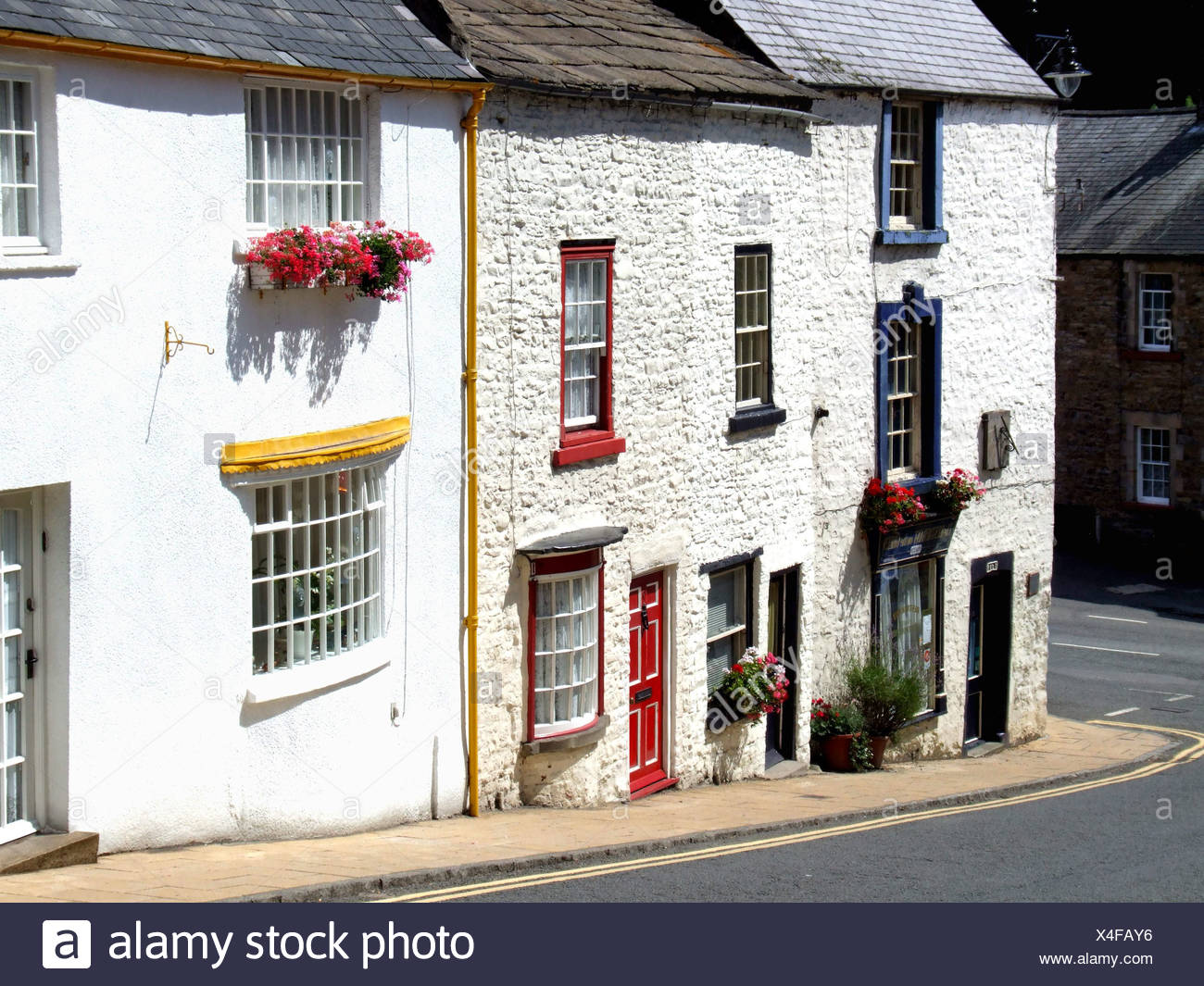 A Row Of White Painted Cottages Brightly Painted Doors And