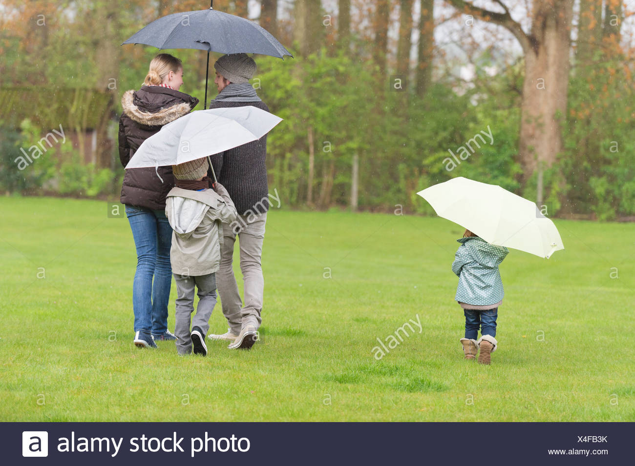 Two People Sharing Umbrella Walking Stock Photos & Two People Sharing