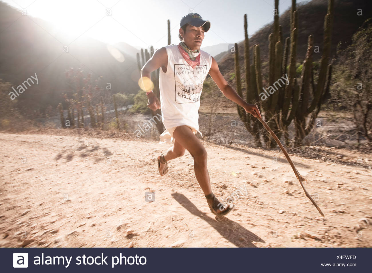 A Tarahumara Runner Running With A Stick As A Pole During An Ultra Marathon In Urique Chihuahua Mexico Stock Photo Alamy