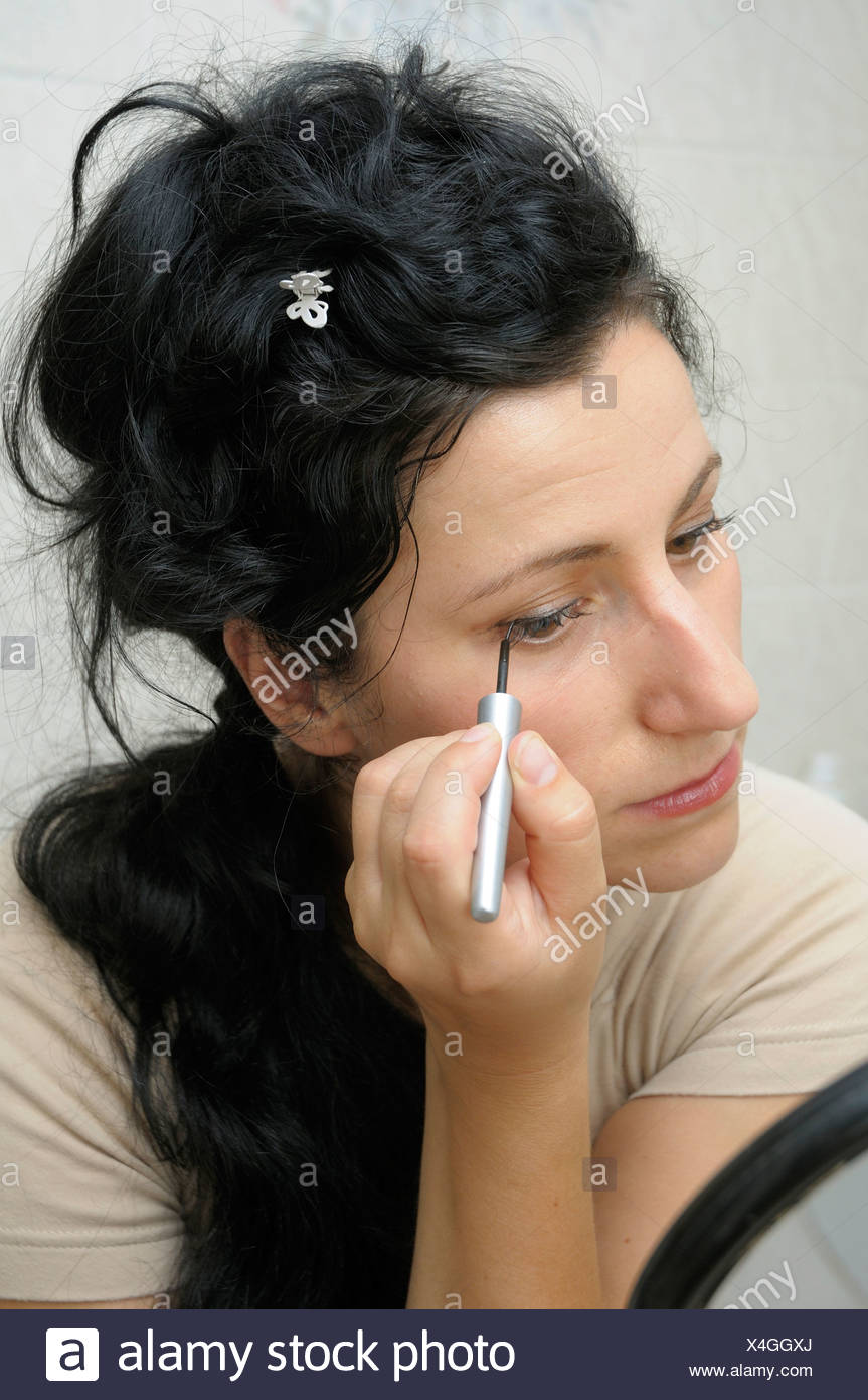 Young woman 28 applying make up Stock Image