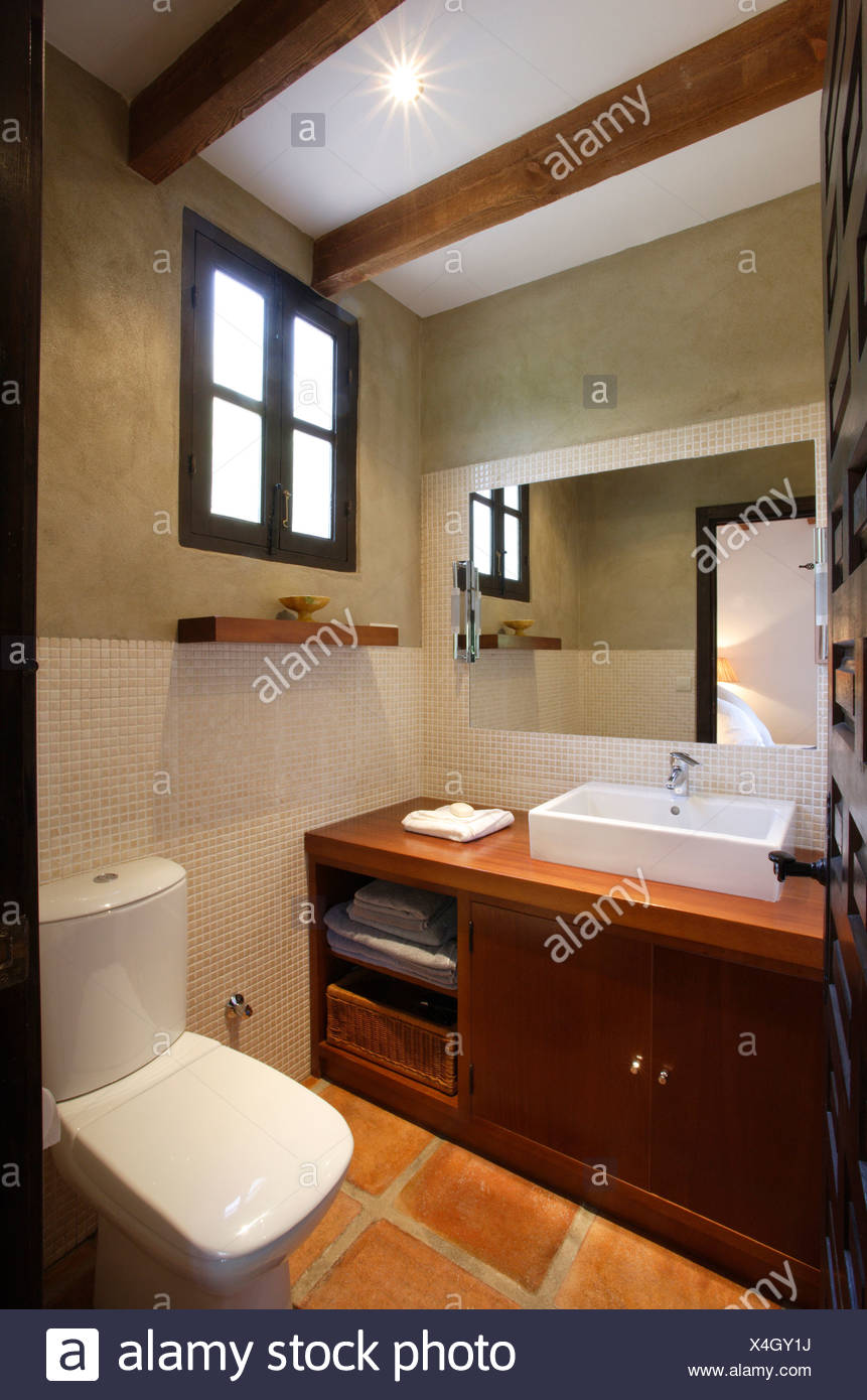 Mirror On Wall Above Rectangular White Basin On Fitted Wood Vanity Unit In Modern Bathroom Stock Photo Alamy