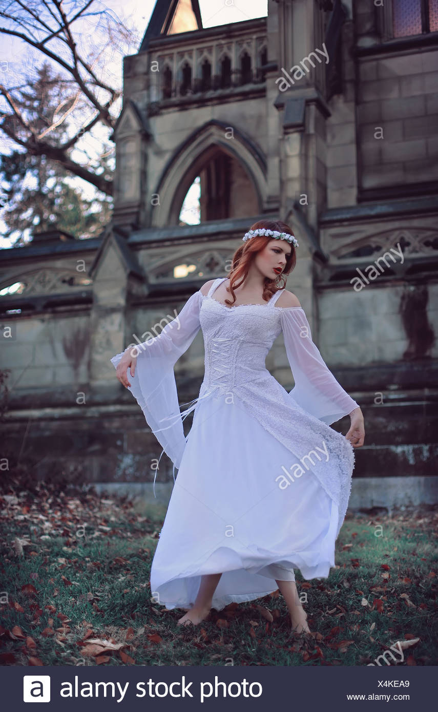 Twirling Girl With Red Hair In Front Of A Large Castle Wearing A