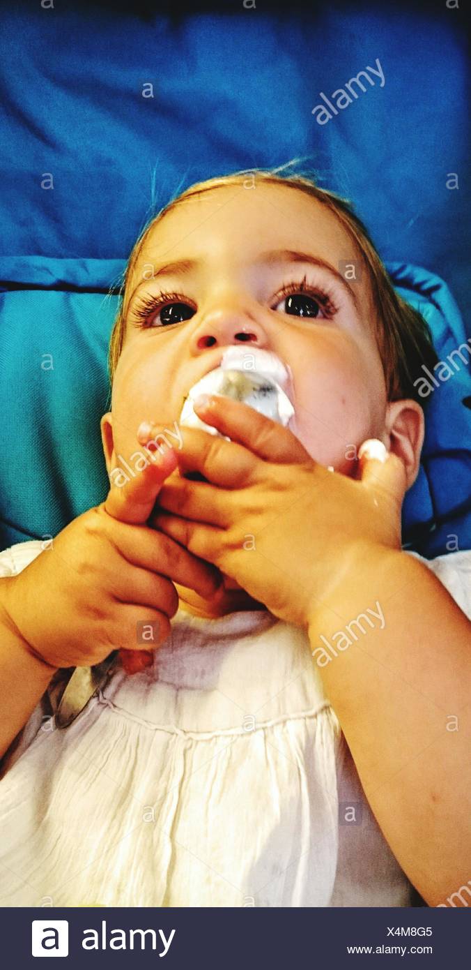 Close Up Of Baby Girl Eating In Crib Stock Photo 278270277 Alamy